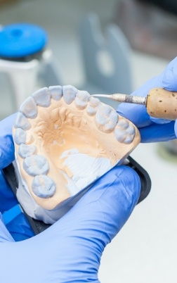 Dental lab technician crafting a denture