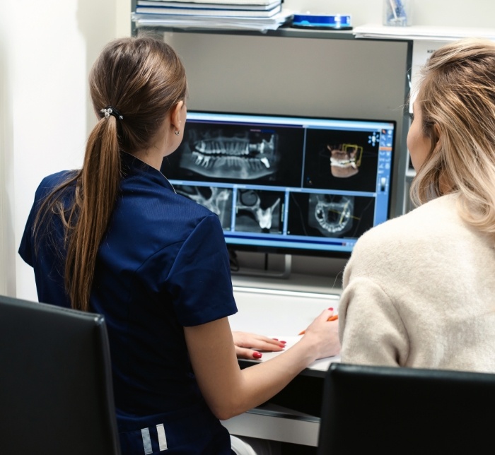 Dental team members looking at all digital x-rays