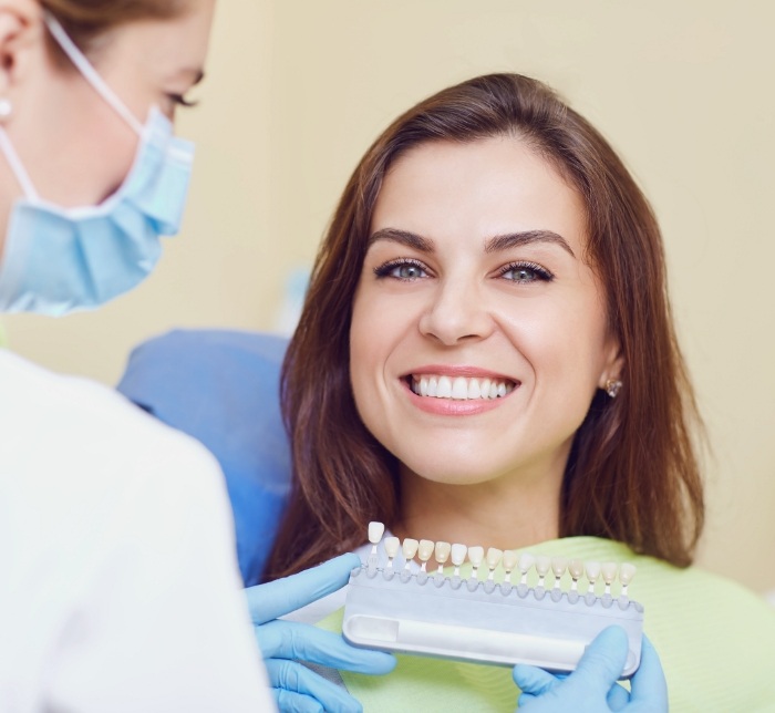 Woman smiling during veneers cosmetic denistry treatment visit