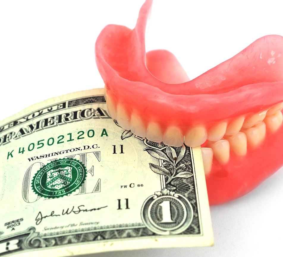 Dollar bill gripped between upper and lower dentures