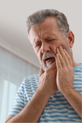 Man in pain before wisdom tooth extractions