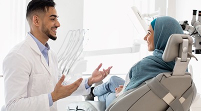 Dentist and patient having friendly conversation