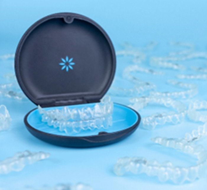 Invisalign aligners in case next to additional trays