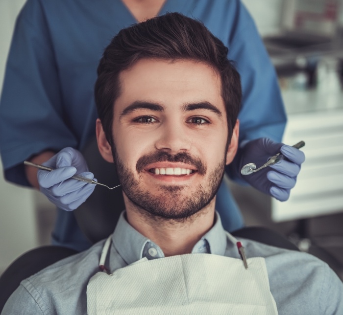 Man smiling during wisdom tooth extraction visit
