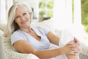 Smiling older woman sitting on couch